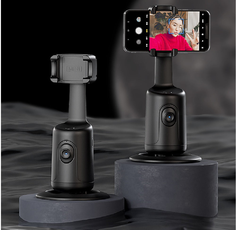 Two black MINI AI auto-tracking phone holders on grey platforms against a dark background.